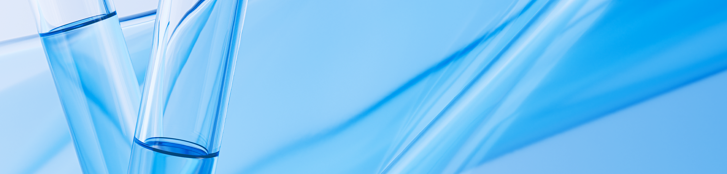 Close up of glass vials with blue liquid with blue waves in the background