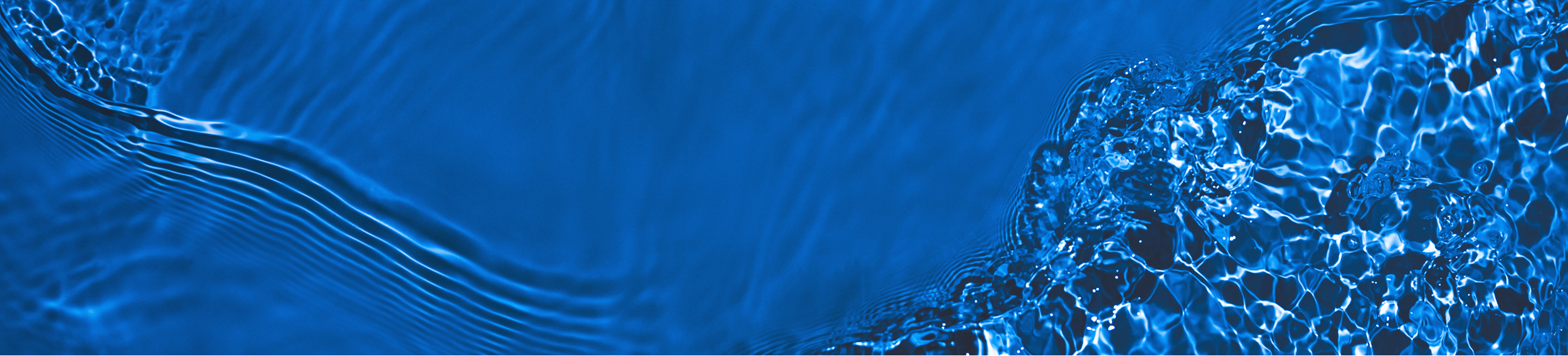Blue water surface with ripples and reflections