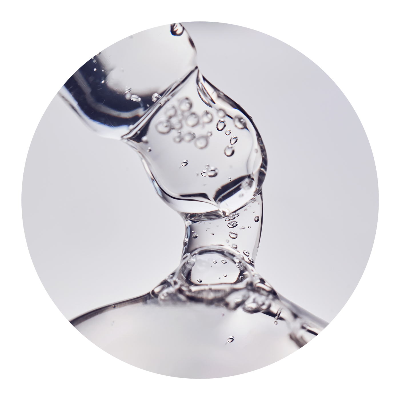 Close up of clear serum coming from a dropper